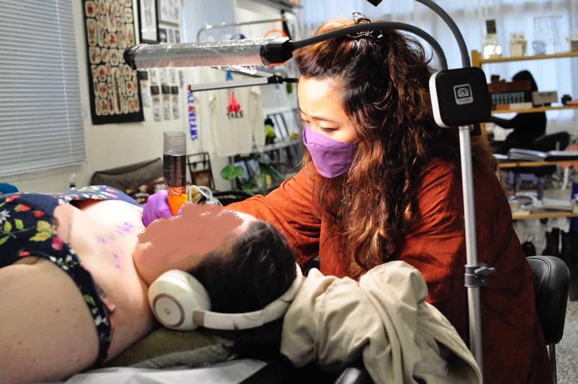 Jing at work in Down The Rabbit Hole Studio, Cebu — fine line tattoo session